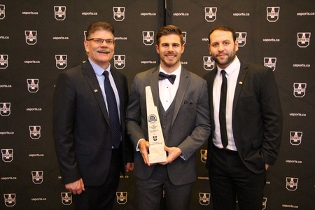 Phil Maillet, centre, with UNB Reds men's hockey coaches Gardiner MacDougall and Rob Hennigar, at the 2017 BLG Awards ceremony, in Calgary.
Maillet became just the second UNB student-athlete to win the prestigious award. Hennigar was the first, in 2008. (Photo: Andy Campbell/UNB Athletics)