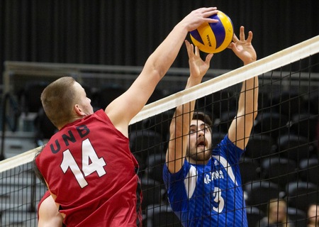 UNB's Herb Compagner executes a block on a Montreal attack during Saturday's 3-2 loss to the Carabins. (Photo: James West/for UNB Athletics)