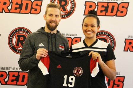 Olivia Rowinski, right, stands with Reds head coach Jon Crossland. Rowinski, a standout with FDSA teams in recent years, has signed a U SPORTS Letter of Intent and will join the Reds in the 2019-20 season. (Photo: Andy Campbell/UNB Athletics)