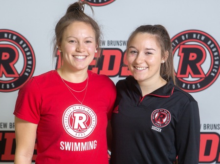 Leah Smal, left, is a member of the Reds women's swim team. Her younger sister Erin, right, is part of the Reds women's soccer team. (Photo: Cameron Fitch/UNB Media Services)