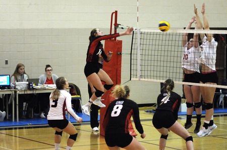UNB's Adora Rooyakkers plays the ball to Memorial's court during Sunday's 3-0 Reds win. (Photo: Acadia Athletics)